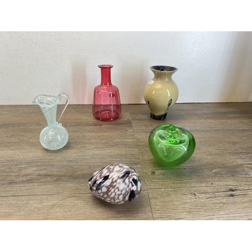 414 - A collection of glassware to include Caithness Moonflower paperweight, Victorian cranberry vase, vas... 