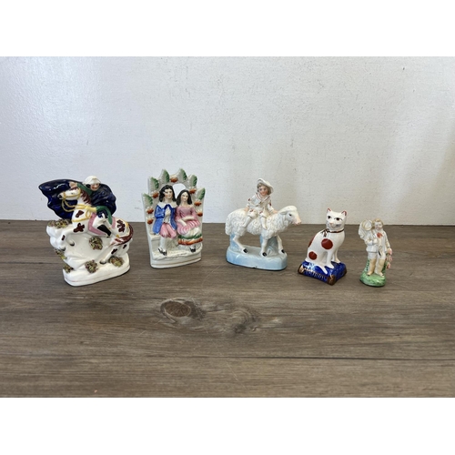 426 - A collection of Staffordshire pottery flatback figurines