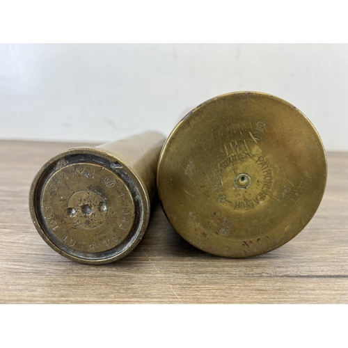 432 - Two brass shell cases, one dated 1915 and one 1953 - largest approx. 23cm high