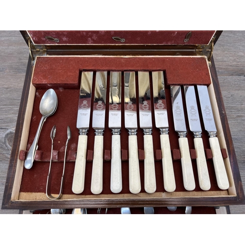 444 - A 1920s oak cased canteen of cutlery