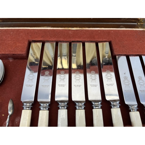 444 - A 1920s oak cased canteen of cutlery