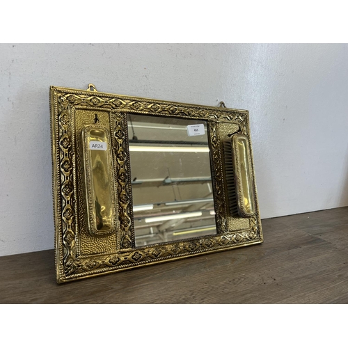 455 - A vintage embossed brass rectangular wall mirror with two piece brush set - approx. 29cm high x 41cm... 