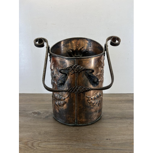 457 - An Arts & Crafts embossed copper coal bucket with wrought iron handle - approx. 40cm high