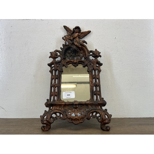 466 - A 19th century style Beatrice cast iron mirror with Putti design top and scroll feet - approx. 34cm ... 