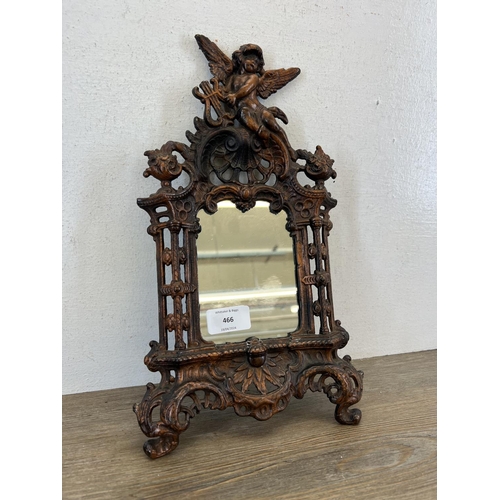 466 - A 19th century style Beatrice cast iron mirror with Putti design top and scroll feet - approx. 34cm ... 