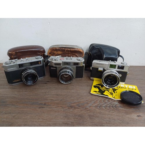 683 - Three cased Japanese 35mm rangefinder cameras, one Petri Racer with instruction manual, one Taron VR... 