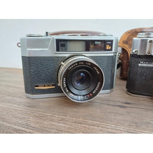 683 - Three cased Japanese 35mm rangefinder cameras, one Petri Racer with instruction manual, one Taron VR... 