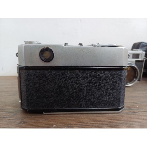 683 - Three cased Japanese 35mm rangefinder cameras, one Petri Racer with instruction manual, one Taron VR... 