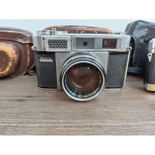 683 - Three cased Japanese 35mm rangefinder cameras, one Petri Racer with instruction manual, one Taron VR... 