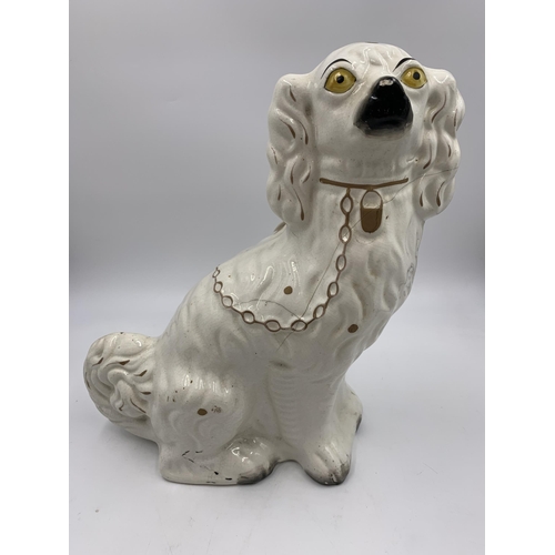 301 - A pair of Staffordshire pottery flatback spaniel dog figurines - approx. 32cm high