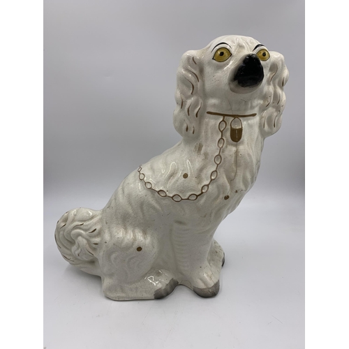 301 - A pair of Staffordshire pottery flatback spaniel dog figurines - approx. 32cm high