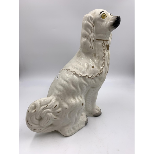 301 - A pair of Staffordshire pottery flatback spaniel dog figurines - approx. 32cm high