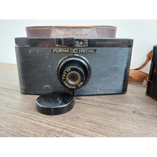 686 - Two cased mid 20th century Bakelite cameras for 127 film, one Photo-Magic and one Purma Special