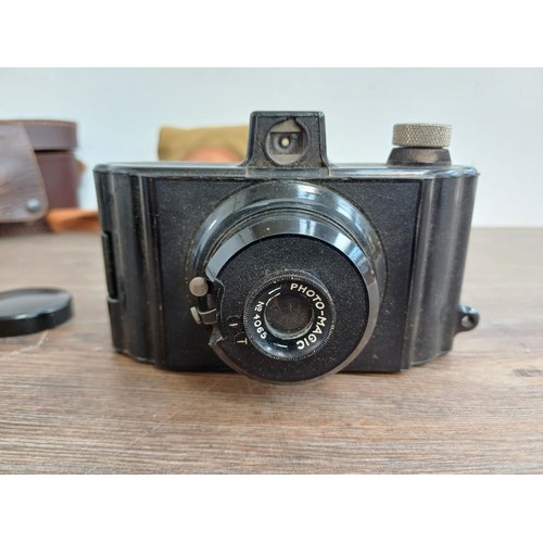 686 - Two cased mid 20th century Bakelite cameras for 127 film, one Photo-Magic and one Purma Special