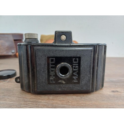 686 - Two cased mid 20th century Bakelite cameras for 127 film, one Photo-Magic and one Purma Special