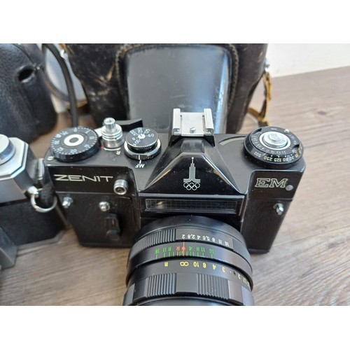 687 - Three vintage 35mm SLR cameras, one cased KMZ Zenit EM fitted with Helios-44M 2/58 lens, one cased M... 