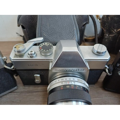 687 - Three vintage 35mm SLR cameras, one cased KMZ Zenit EM fitted with Helios-44M 2/58 lens, one cased M... 