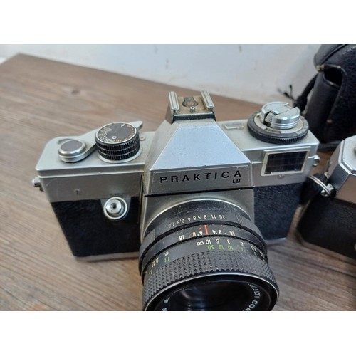 687 - Three vintage 35mm SLR cameras, one cased KMZ Zenit EM fitted with Helios-44M 2/58 lens, one cased M... 