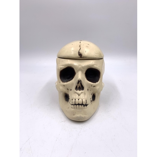 335 - A ceramic skull jar - approx. 13cm high