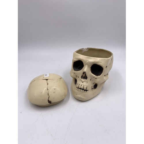 335 - A ceramic skull jar - approx. 13cm high