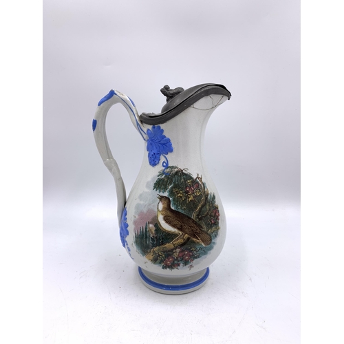 339 - Two 19th century ceramic jugs with pewter lids, one stamped C.H. Birds and one Imari style - approx.... 