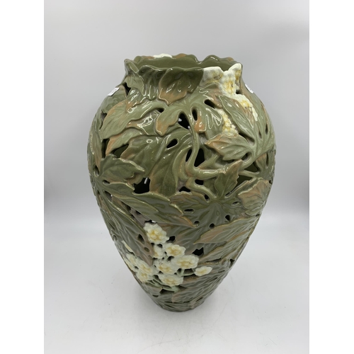 345 - A Japanese earthenware pierced vase decorated with chrysanthemum flowers with seal mark to base (pos... 