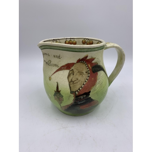 345A - A Royal Doulton D2537 Jester jug signed Noke - approx. 14.5cm high