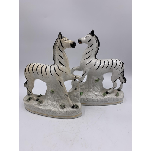 346 - A pair of Staffordshire pottery flatback zebra figurines - approx. 22cm high