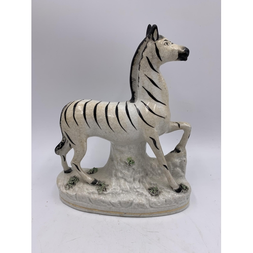 346 - A pair of Staffordshire pottery flatback zebra figurines - approx. 22cm high