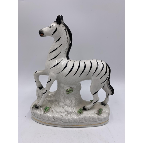 346 - A pair of Staffordshire pottery flatback zebra figurines - approx. 22cm high