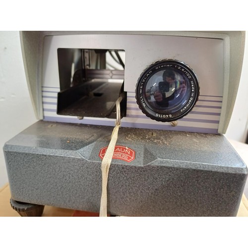 693 - A boxed Braun Paximat N12 slide projector with remote control, boxed slides and three SupaSnaps sing... 