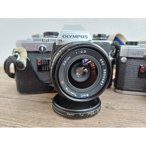 694 - Three Olympus OM10 354mm SLR cameras, one fitted with Zuiko MC 1:1.8 f=50mm lens, one body only and ... 