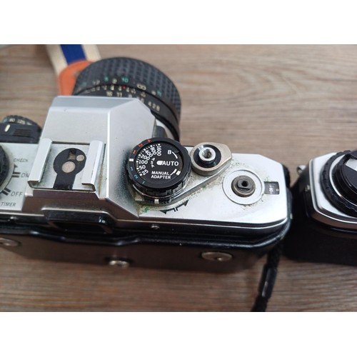 694 - Three Olympus OM10 354mm SLR cameras, one fitted with Zuiko MC 1:1.8 f=50mm lens, one body only and ... 