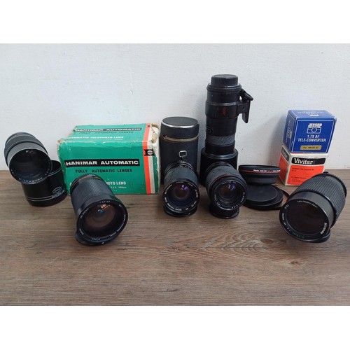 695 - A collection of tele-converters and lenses to include boxed Hanimar F:3.5 200m automatic telephoto f... 