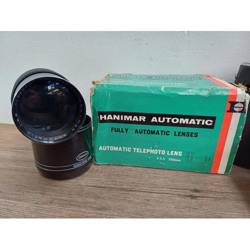 695 - A collection of tele-converters and lenses to include boxed Hanimar F:3.5 200m automatic telephoto f... 