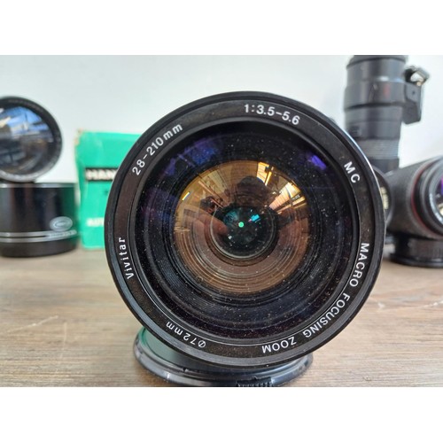 695 - A collection of tele-converters and lenses to include boxed Hanimar F:3.5 200m automatic telephoto f... 