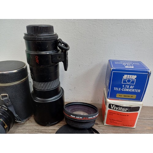 695 - A collection of tele-converters and lenses to include boxed Hanimar F:3.5 200m automatic telephoto f... 