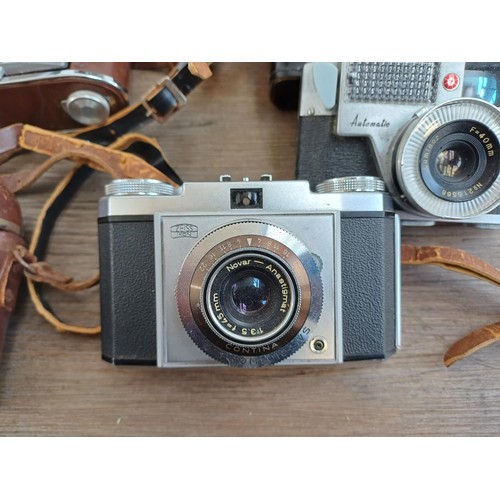 703 - A collection of vintage cameras to include Kodak Brownie Reflex pseudo TLR, Zeiss Ikon Contina 1a 52... 