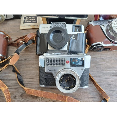 703 - A collection of vintage cameras to include Kodak Brownie Reflex pseudo TLR, Zeiss Ikon Contina 1a 52... 