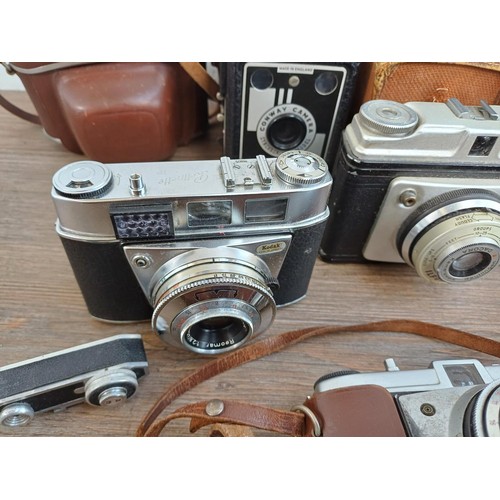 703 - A collection of vintage cameras to include Kodak Brownie Reflex pseudo TLR, Zeiss Ikon Contina 1a 52... 