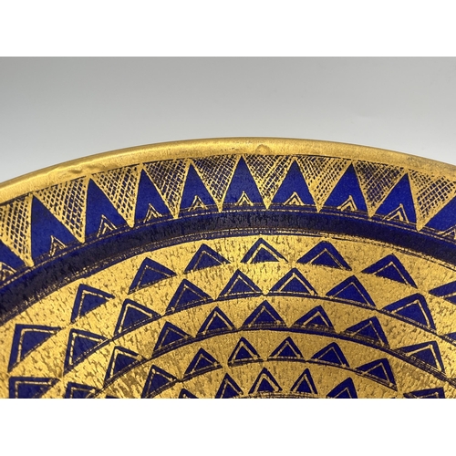 370 - A Mary Rich studio pottery circular footed fruit bowl on cobalt blue ground with gilt geometric patt... 