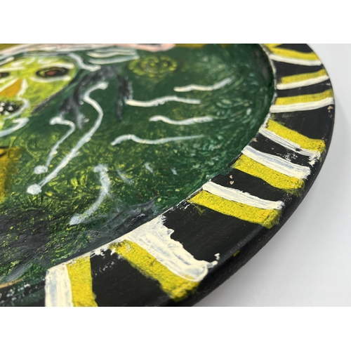 383 - A 1975 John Piper studio pottery charger with female figure decoration, signed to reverse - approx. ... 