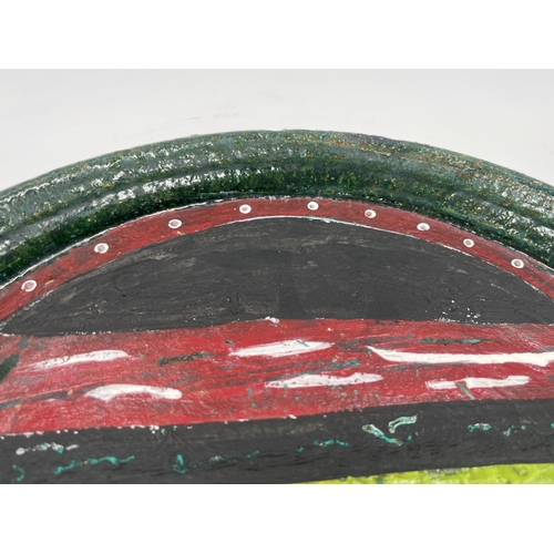 384 - A John Piper studio pottery charger with outré face decoration - approx. 29cm diameter