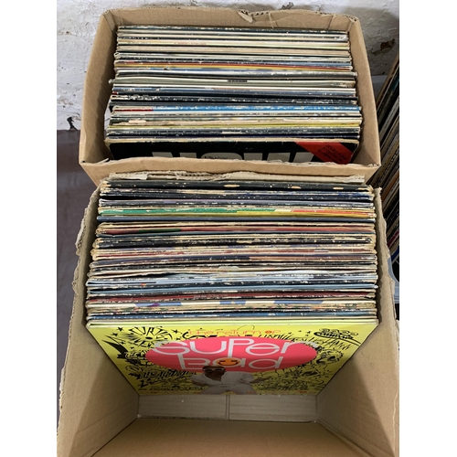 760 - Three boxes containing a collection of vinyl records to include The Beatles, Courtney Pine, War feat... 