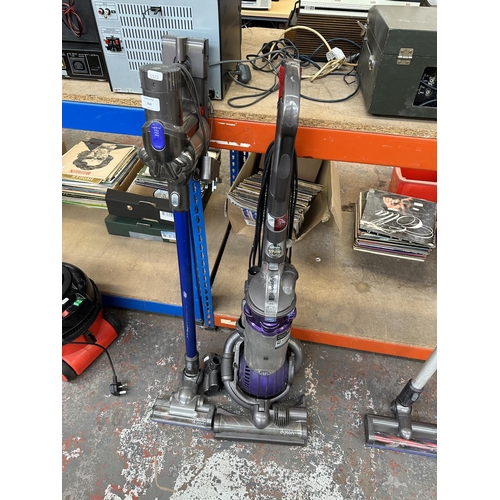 854 - Two Dyson bagless vacuum cleaners, one DC44 Animal cordless with charger and one DC25 upright