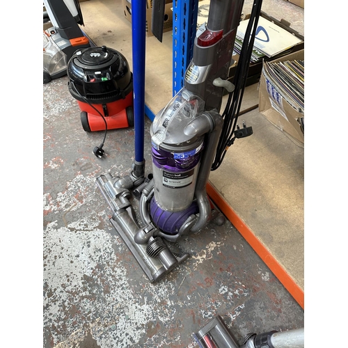 854 - Two Dyson bagless vacuum cleaners, one DC44 Animal cordless with charger and one DC25 upright