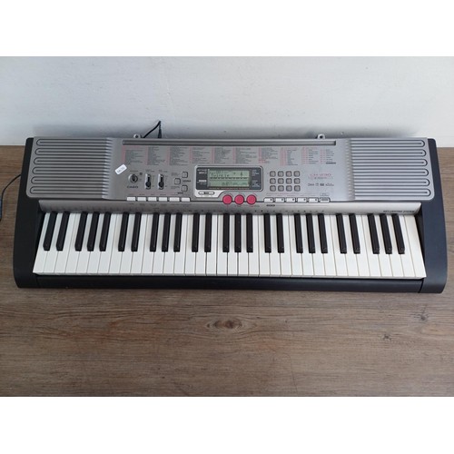 785 - A Casio LK-230 electronic keyboard with power adaptor