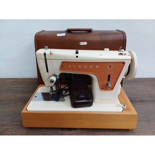 858A - A cased Singer 239 electric sewing machine with foot pedal