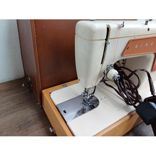 858A - A cased Singer 239 electric sewing machine with foot pedal