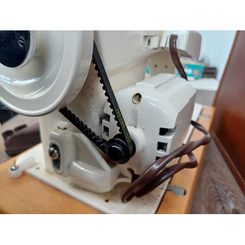 858A - A cased Singer 239 electric sewing machine with foot pedal